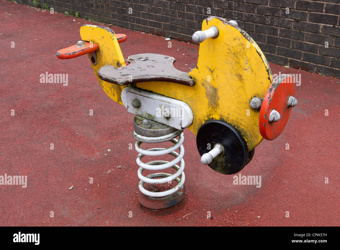 Children's play area bouncy spring plane.  Old worn and weathered. Stock Photo