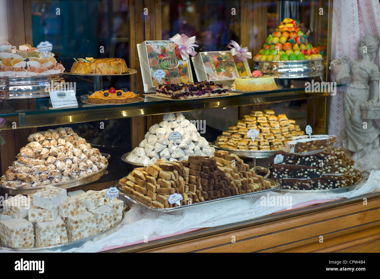 Cakes, sweets and pastries in shop window of luxury patticeria, caffe