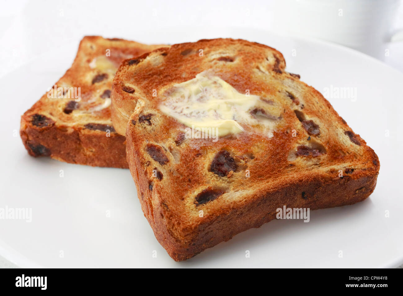 Heart healthy, polyunsaturated sunflower oil margarine, melting into raisin toast. Stock Photo