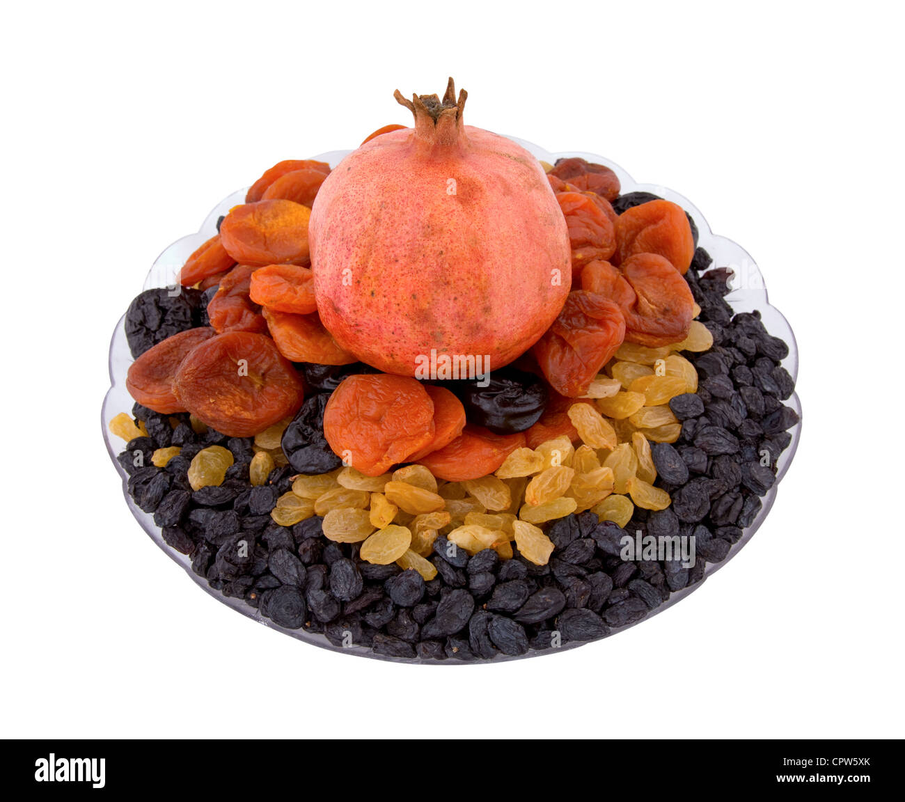 Pomegranate, raisins, dried apricots, prunes on a plate on a white background Stock Photo