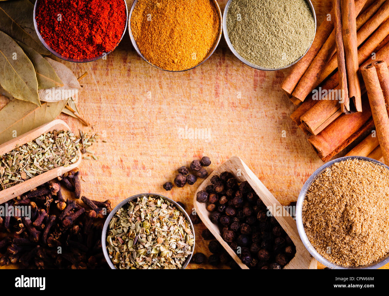 Frame with different spices on a wooden board Stock Photo