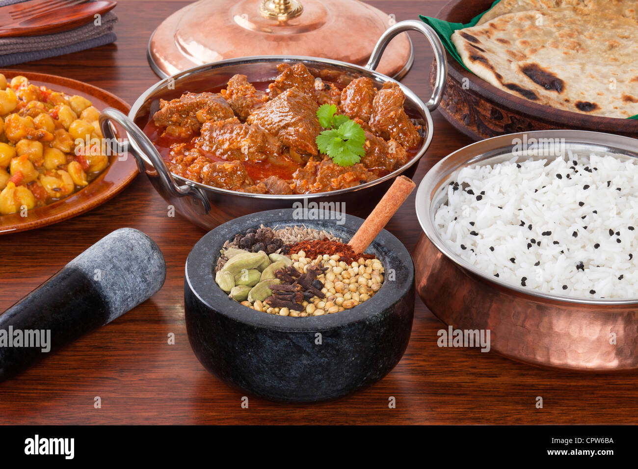 A selection of Indian food and spices, lamb rogan josh, chana masala, spices, basmati rice and parathas Stock Photo