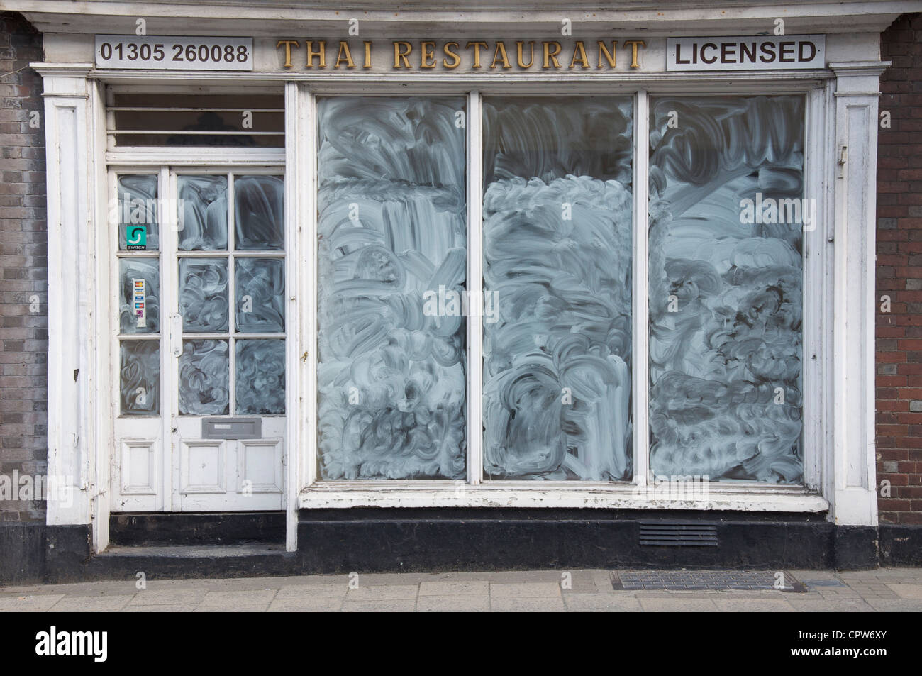 A closed down Thai restaurant, one of many conspicuous high street casualties of the global economic crisis in 2012. Dorchester, Dorset, England, UK. Stock Photo