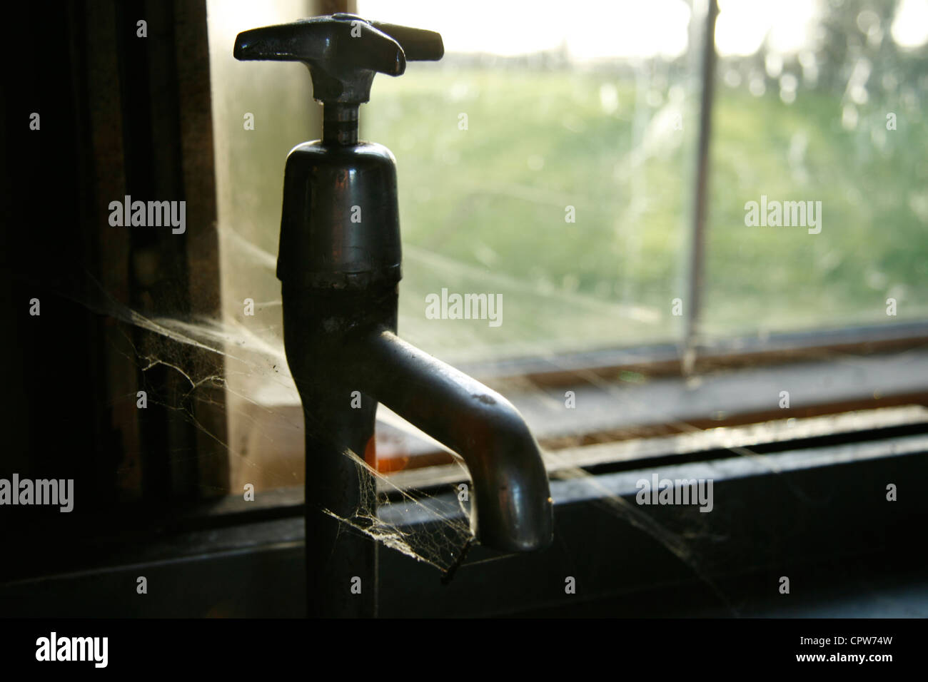 Water mains tap covered with spider webs Stock Photo