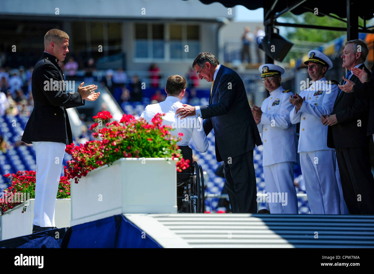 Secretary of Defense Leon Panetta congratulates Kevin Hillery upon his graduation from the U.S. Naval Academy. Despite an accident in April that left him paralyzed, Hillery was still allowed to graduate from the academy. Stock Photo