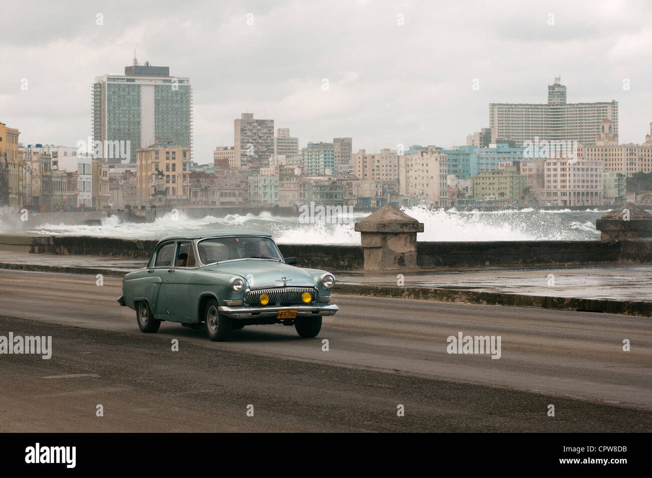 Havana. Cuba. Vintage American car on the Malecon with Centro and Vedado in the background Stock Photo