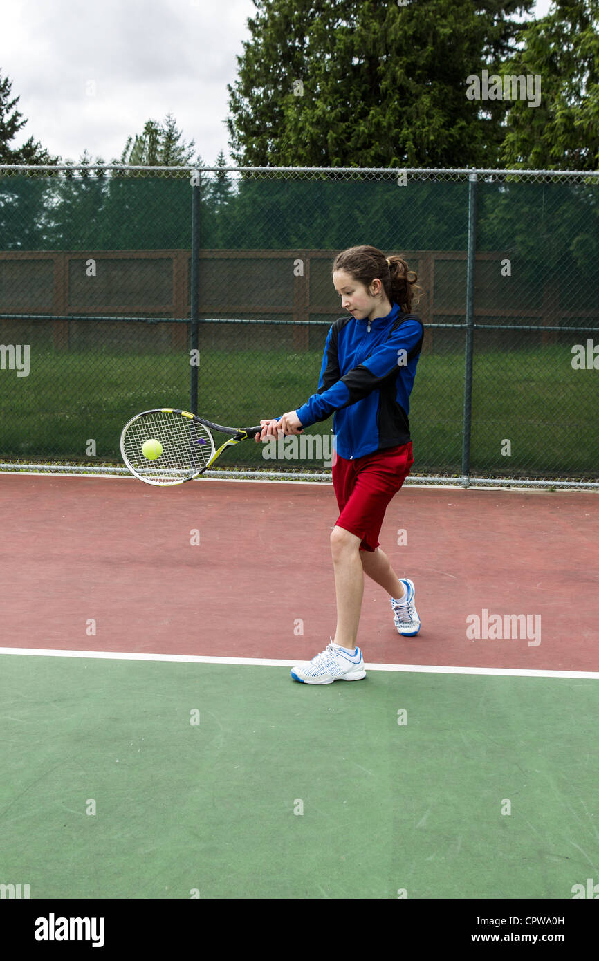 Young girl using a two handed backhand for left hand tennis Player