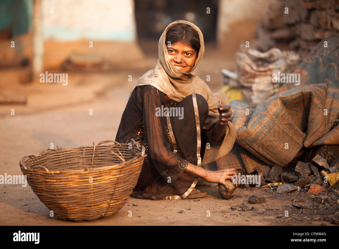 Young girl break coal for easy preburn, Jharia, Dhanbad, Jharkhand