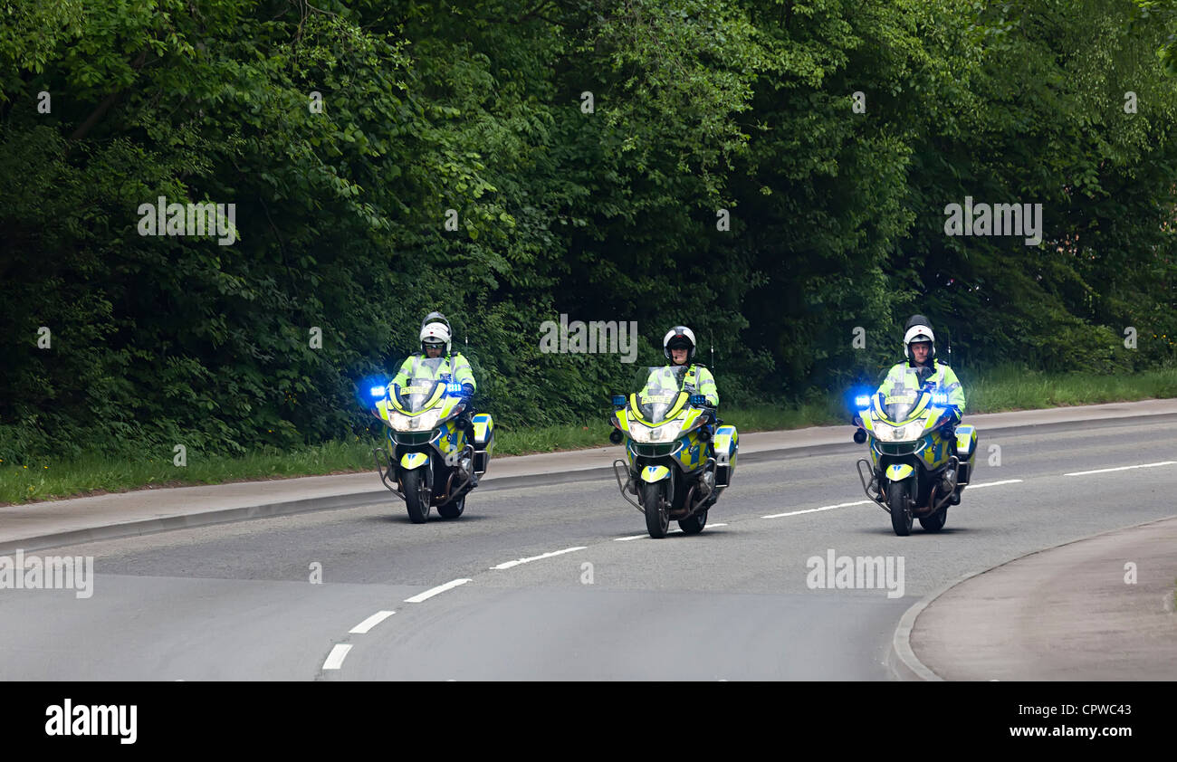 Three police motorcycles with flashing hazard lights Wales UK Stock Photo Alamy