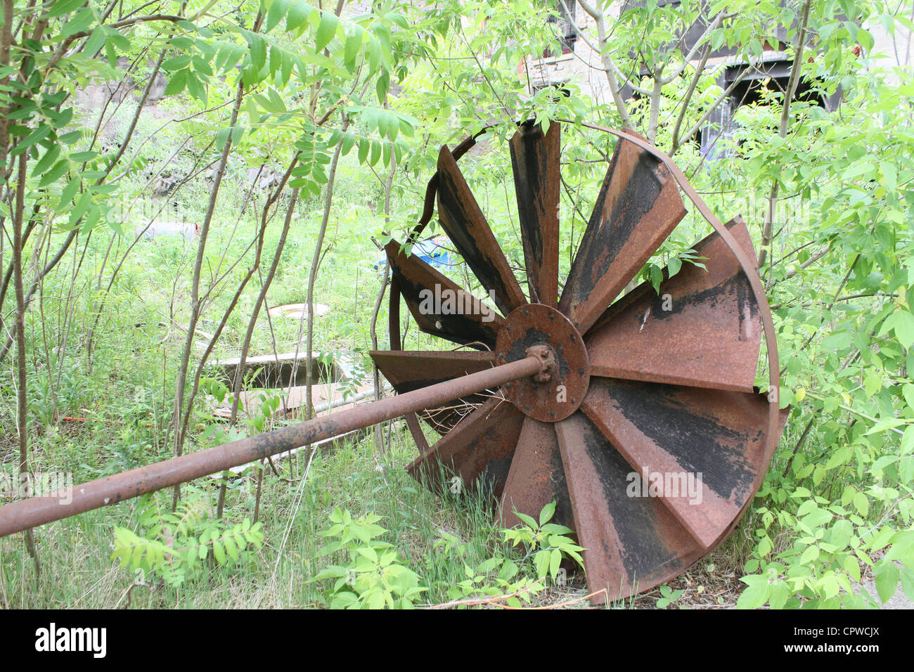 rusted turbine fan abandoned forest Stock Photo