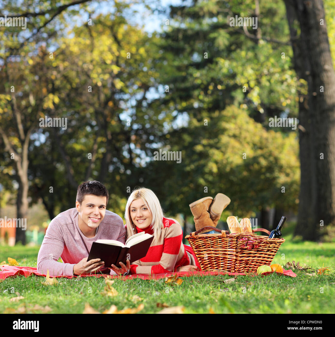 A  couple reading book in a park Stock Photo