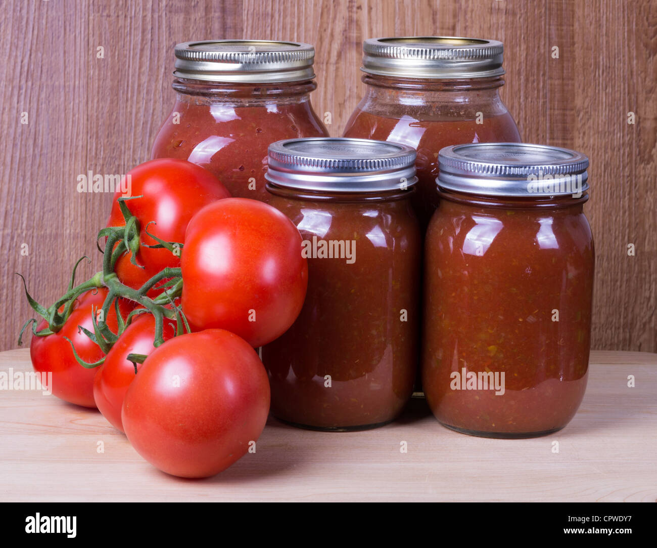 Four jars of tomato sauce with fresh tomatoes Stock Photo Alamy