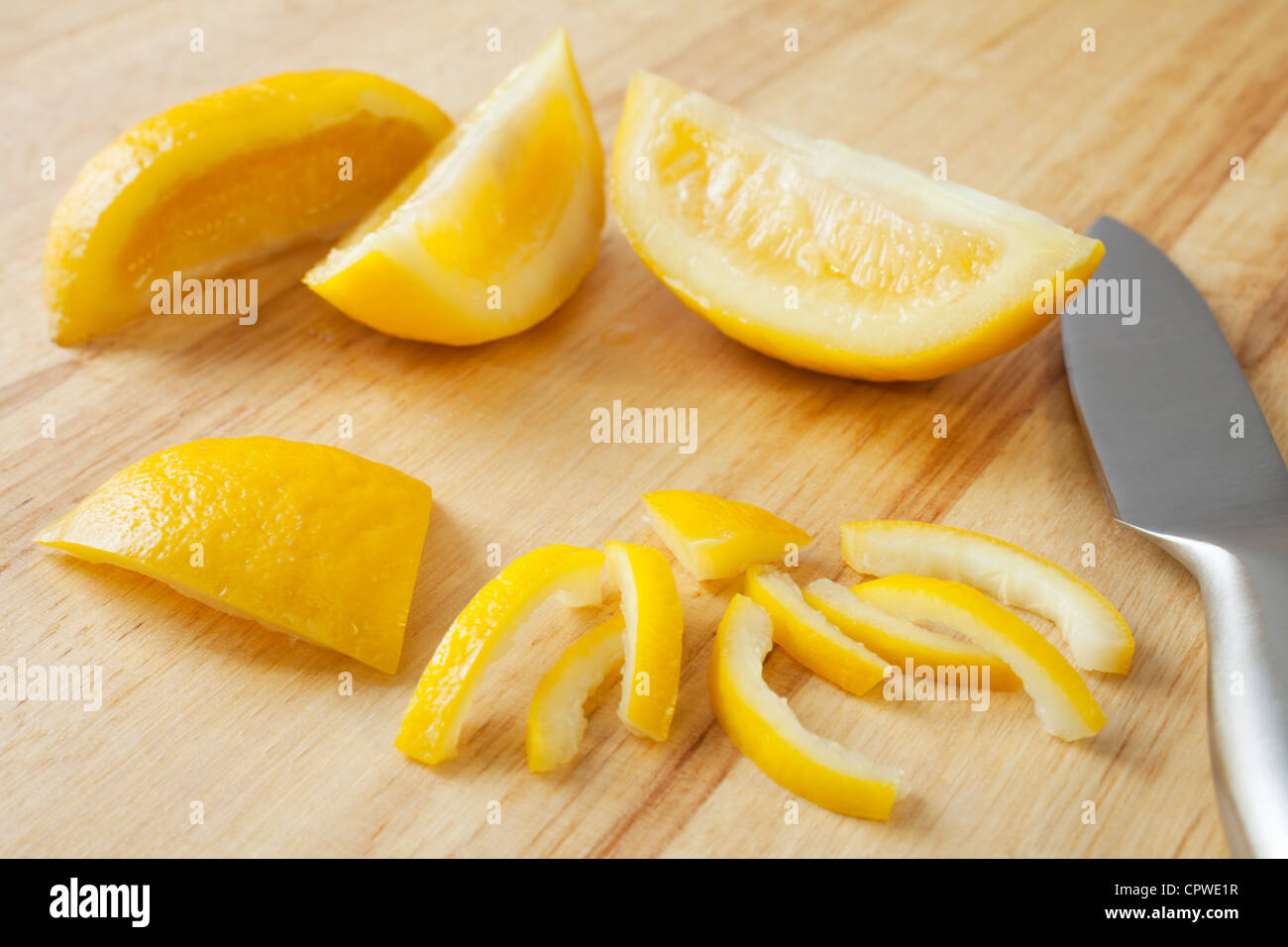 Preserved lemon, staple of Moroccan cuisine, on a chopping board. Stock Photo