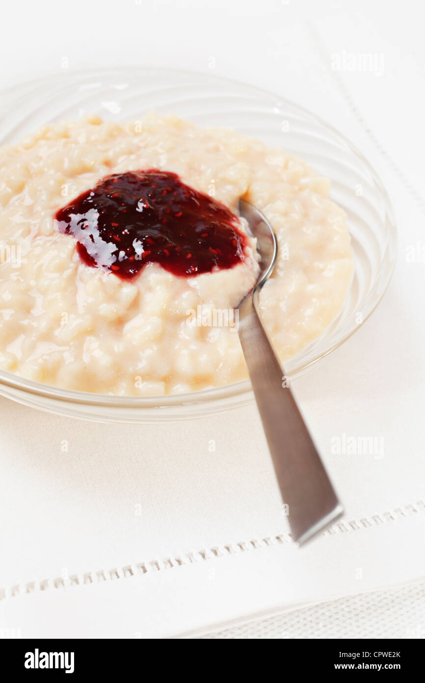 A bowl of rice pudding with raspberry jam. Stock Photo
