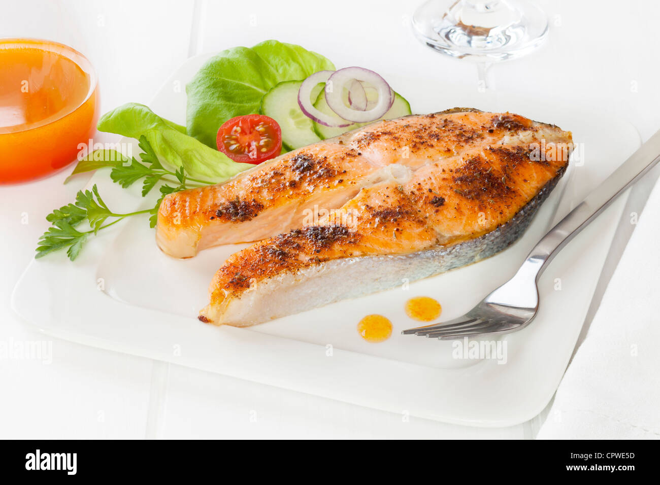 Cajun salmon with salad and spicy dressing. Sometimes called blackened red fish. Stock Photo
