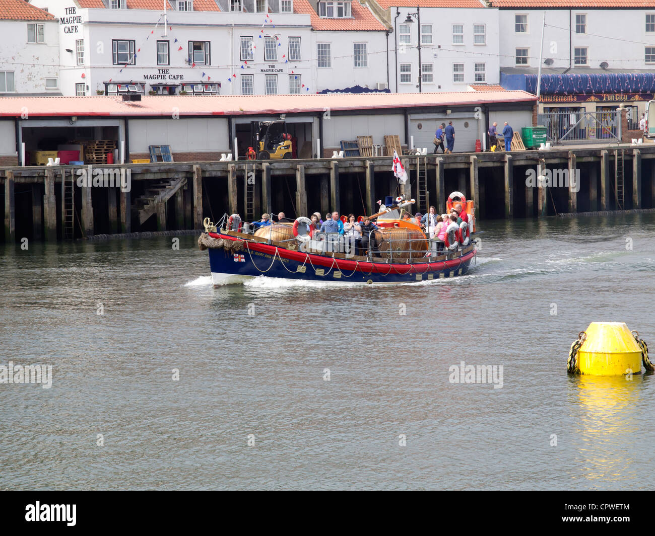 The old Whitby Lifeboat 'Mary Ann Hepworth' inbound passing the Fish Market on a spring pleasure trip in Whitby harbour Stock Photo