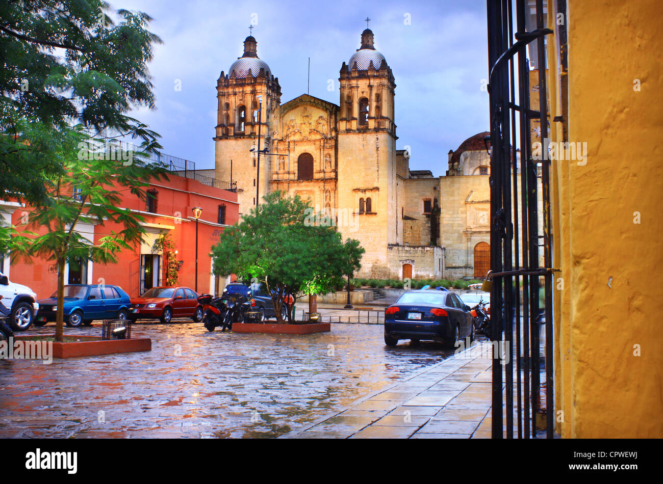 Cobblestone street in colonial Oaxaca leading to Santo Domingo Cathedral. In the evening rain. Stock Photo