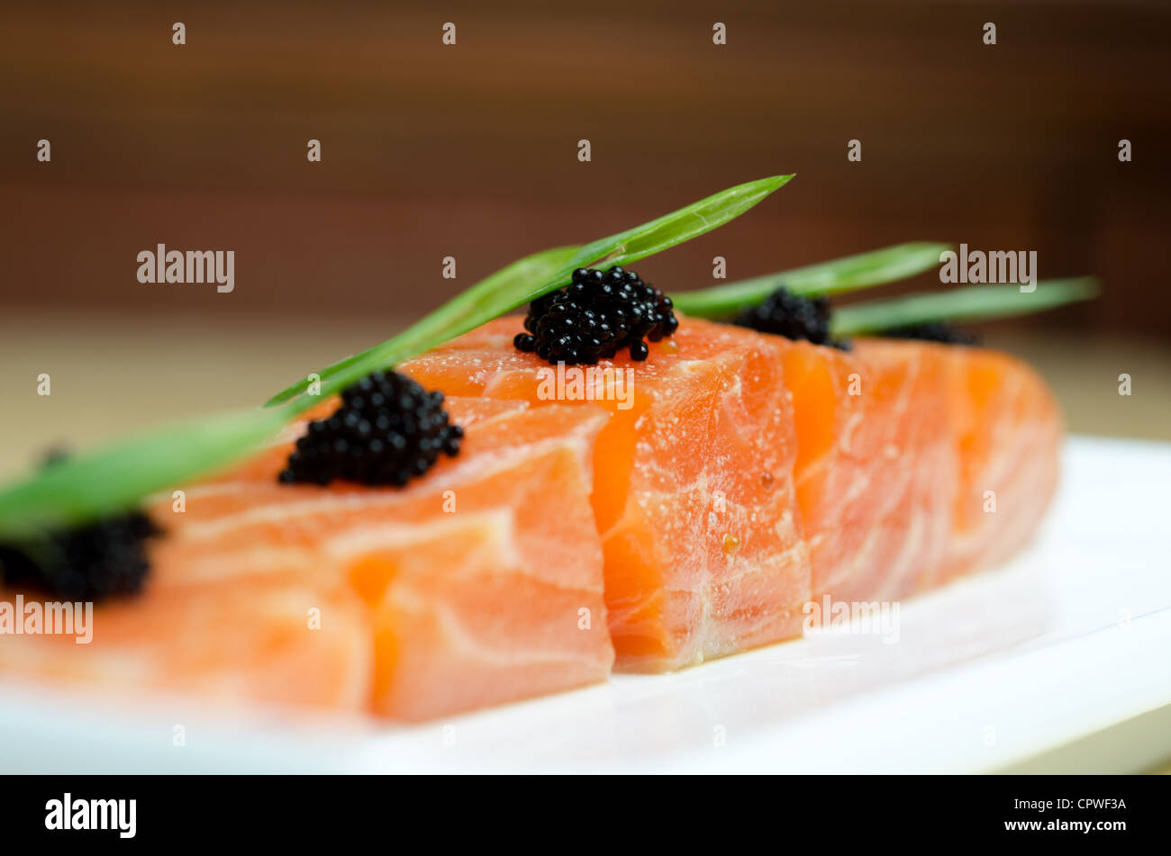 Salmon Slices with black tobiko caviar and greens Stock Photo Alamy
