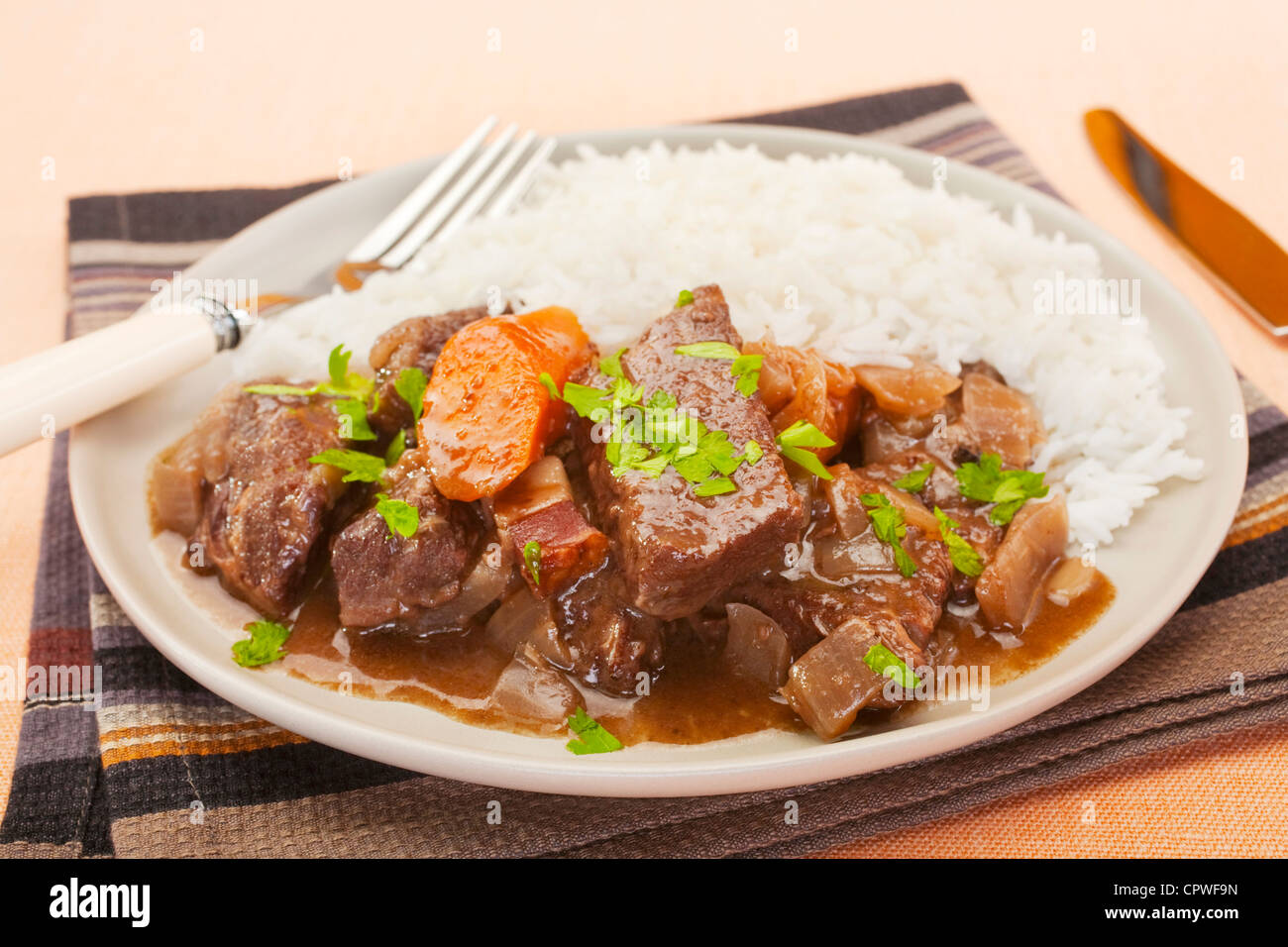 French beef stew in red wine, on a plate with rice. Known as daube de boeuf Provencal. Stock Photo