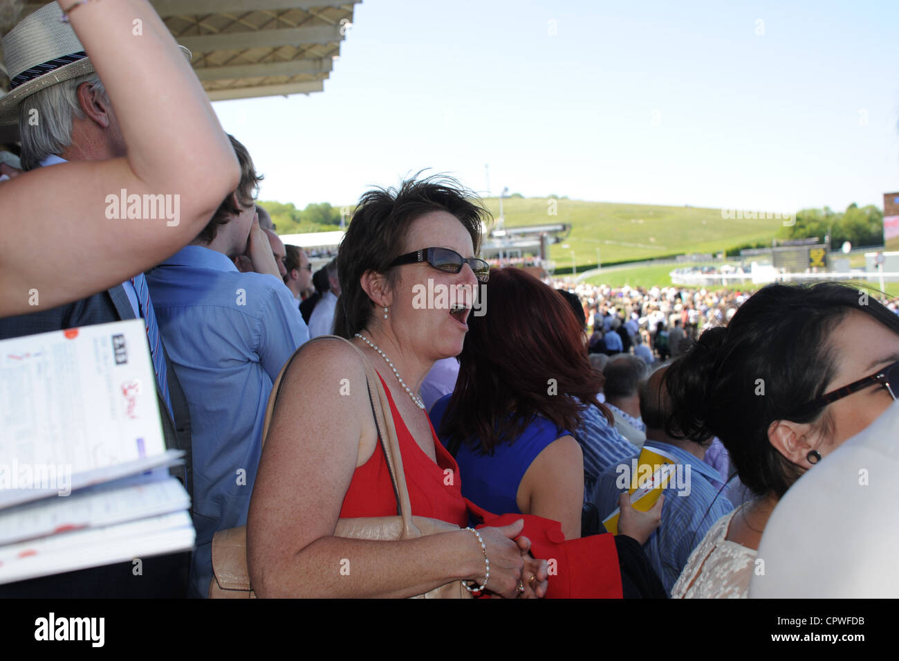 Female spectator getting excited at horse racing Goodwood Racecourse West Sussex UK Stock Photo