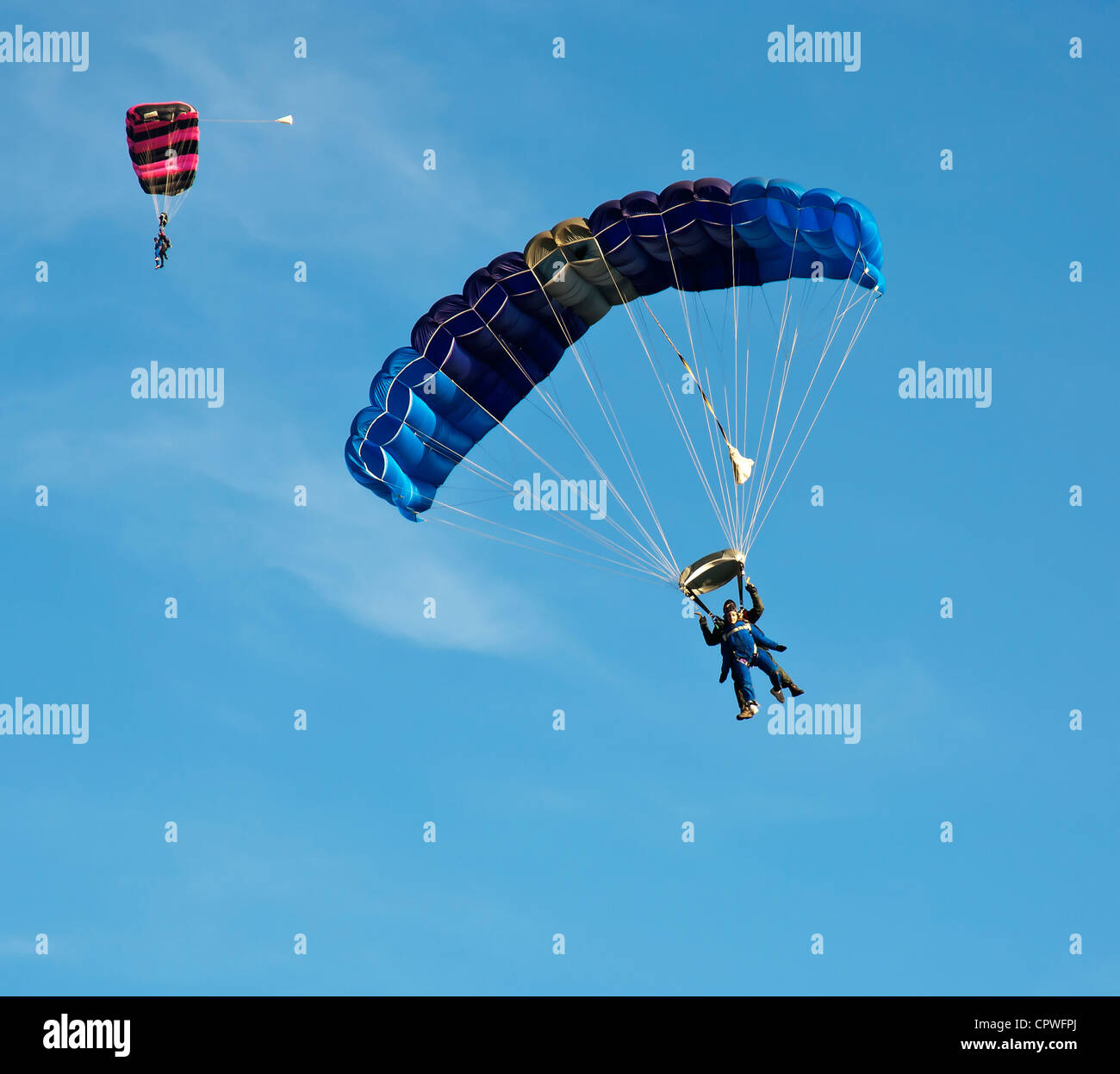 Tandem charity parachute jump against blue sky Stock Photo Alamy