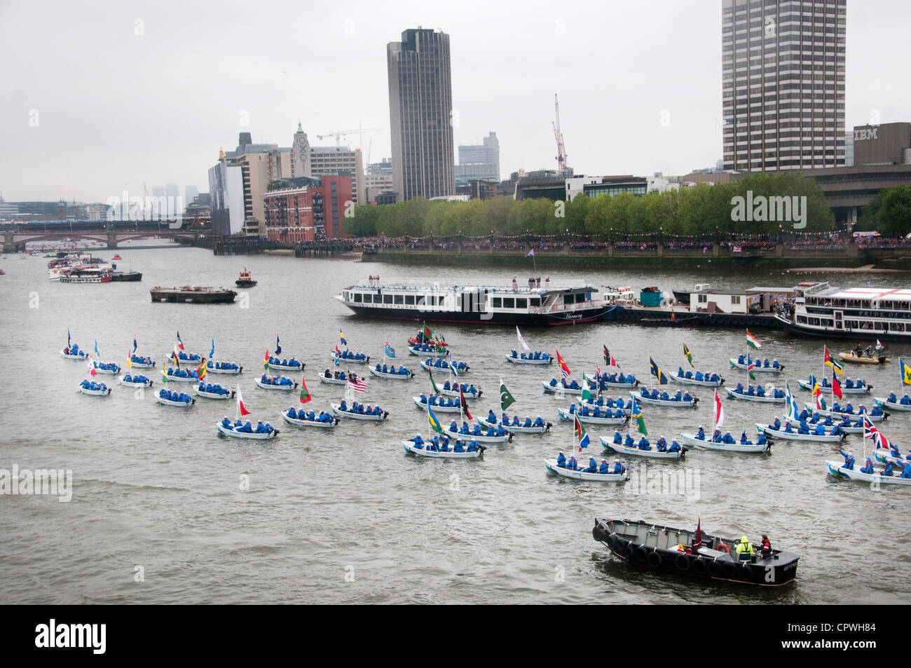 The river Thames flotilla made up of 1000 boats - sea cadets in small boats each with a commonwealth flag. Stock Photo
