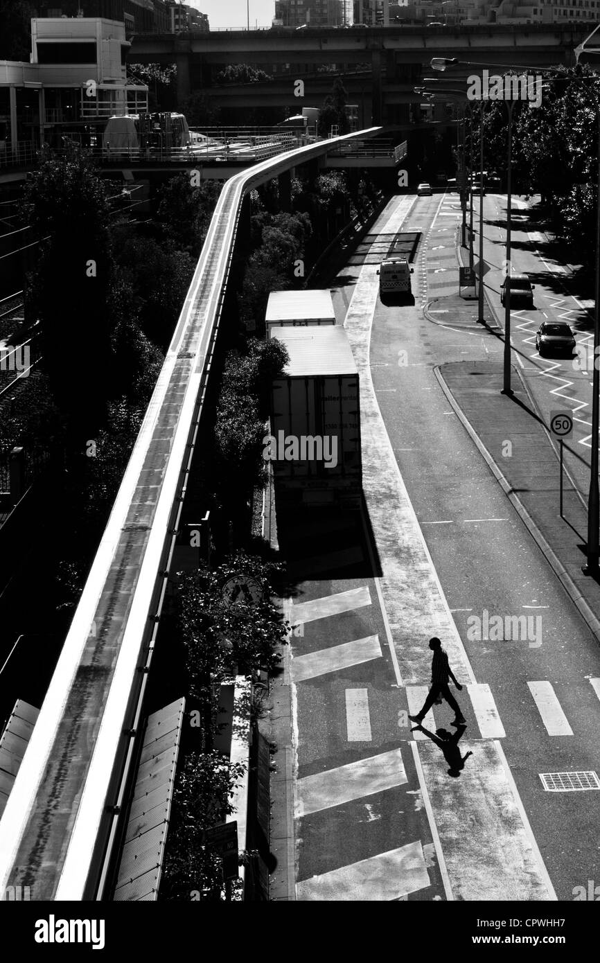 Man crossing the street - Stock Image