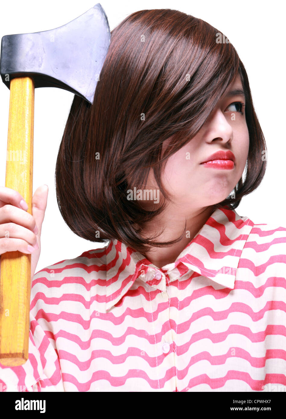 A woman with a hatchet in her hand. Stock Photo