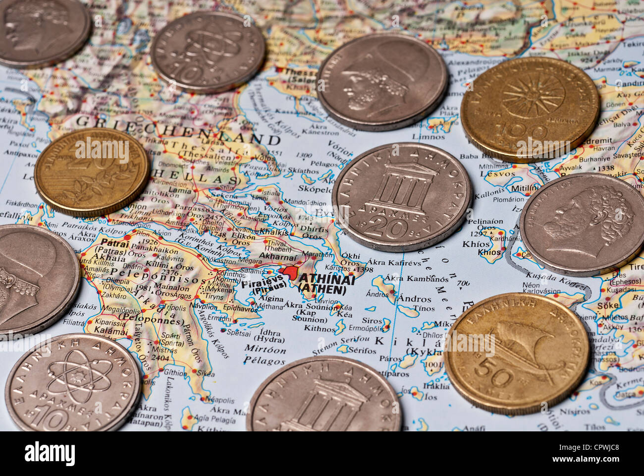 A map of Greece with many drachma coins. Stock Photo