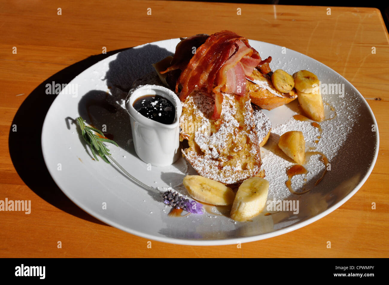 New Zealand breakfast. French toast with bacon, maple syrup and banana