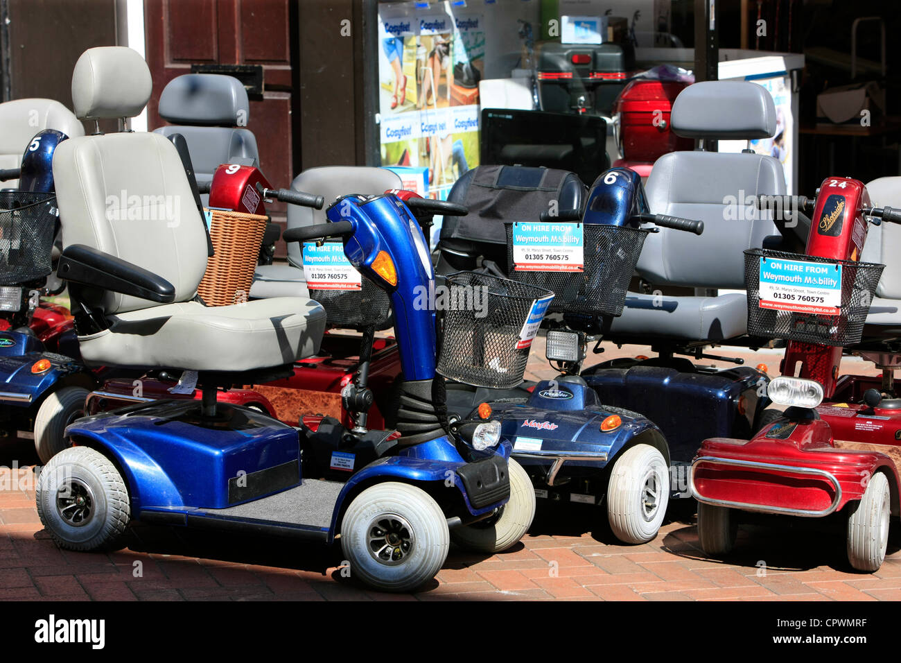 Mobility scooters outside a rental store in Weymouth Stock Photo Alamy