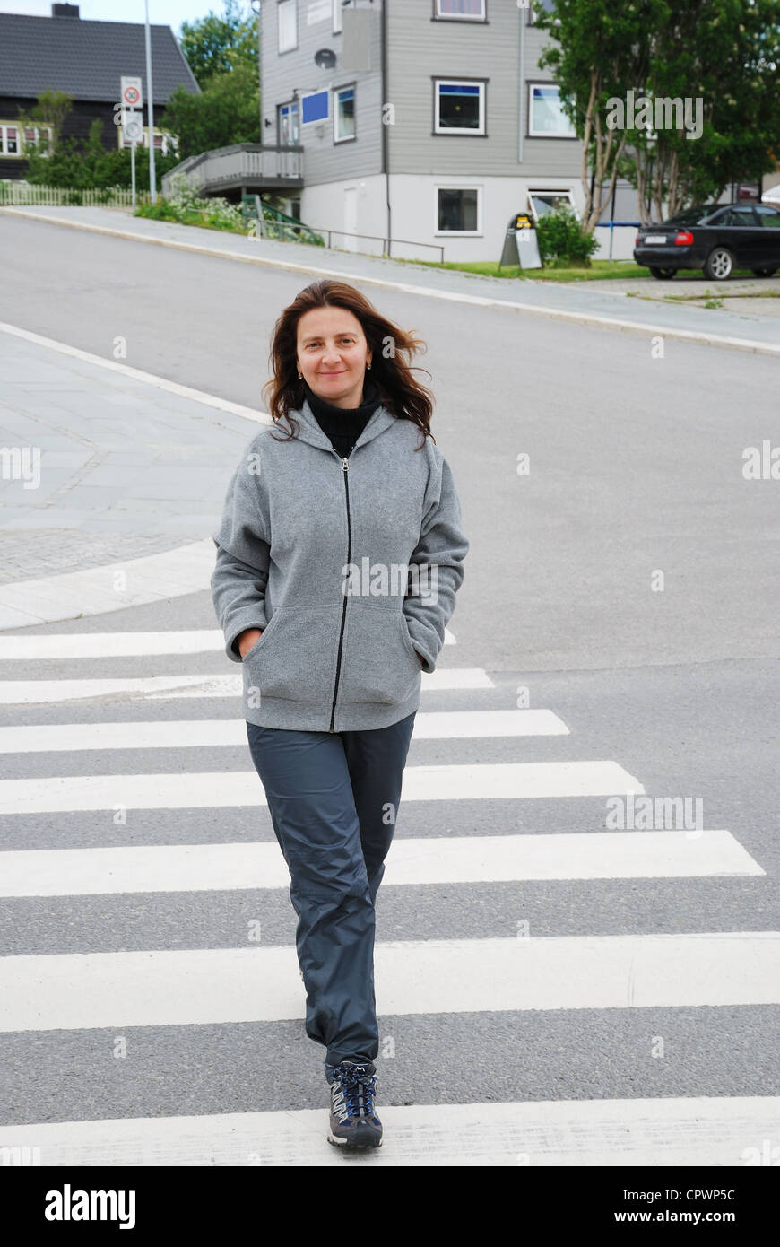 Happy woman on the pedestrian crossing Stock Photo