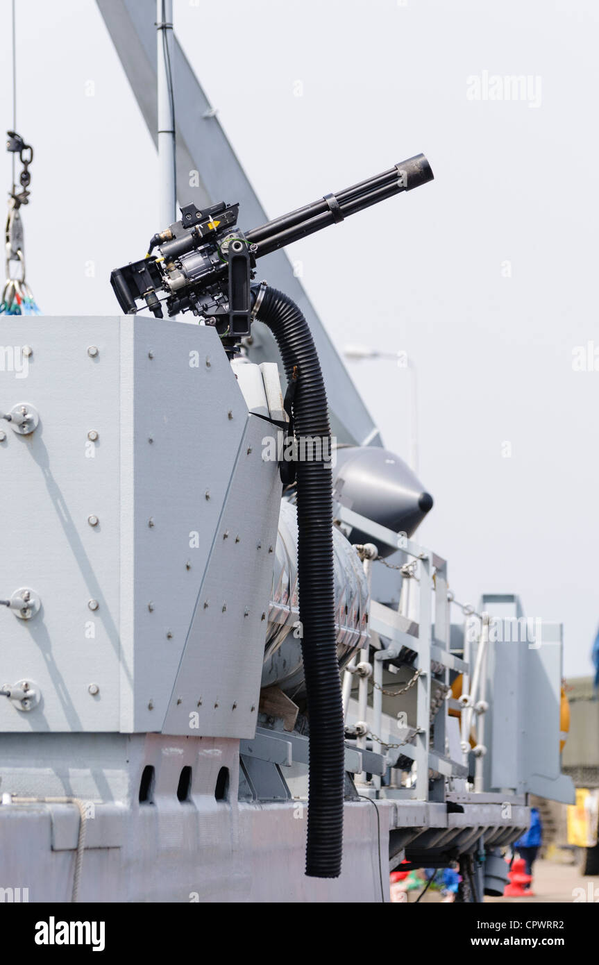 Water cooled gatling machine gun mounted on the side of HMS Bangor Stock Photo