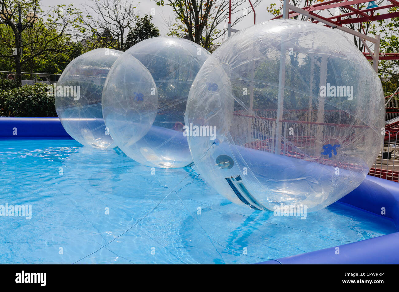 Zorb balls on water in a funfair Stock Photo Alamy