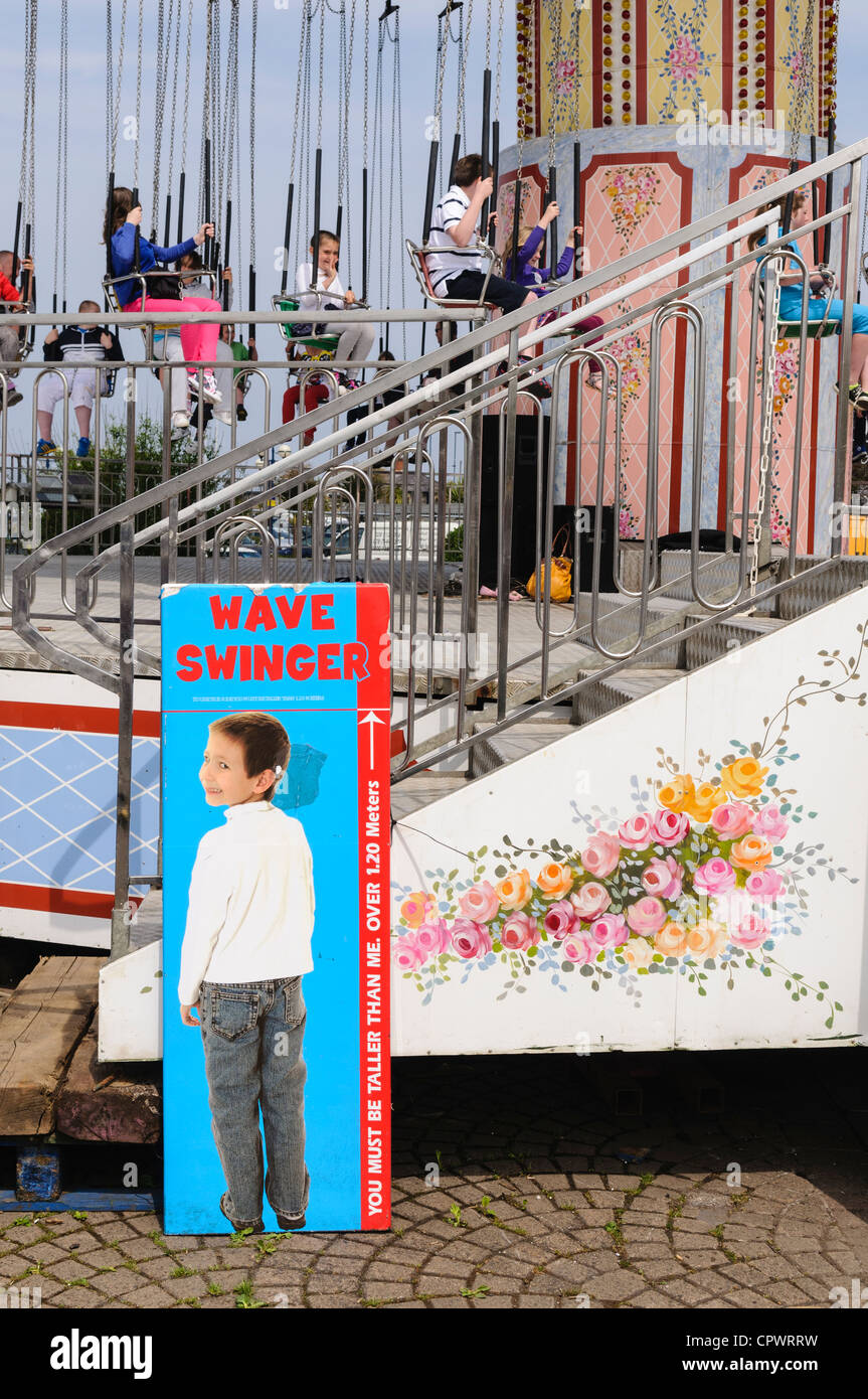 Height restriction sign on "Chairplanes" fairground ride Stock Photo