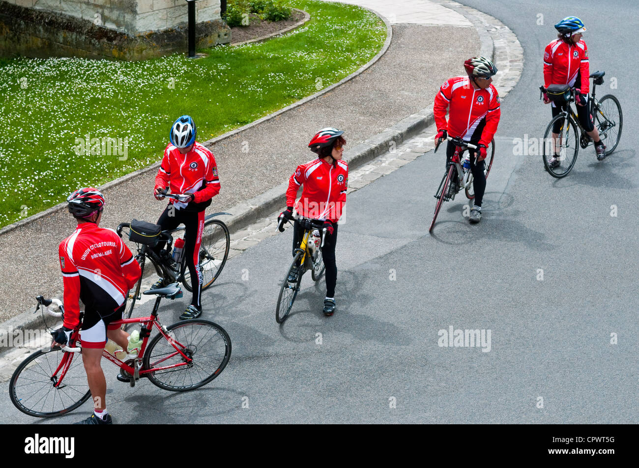 Group of amateur sport cyclists looking at route directions - France. Stock Photo