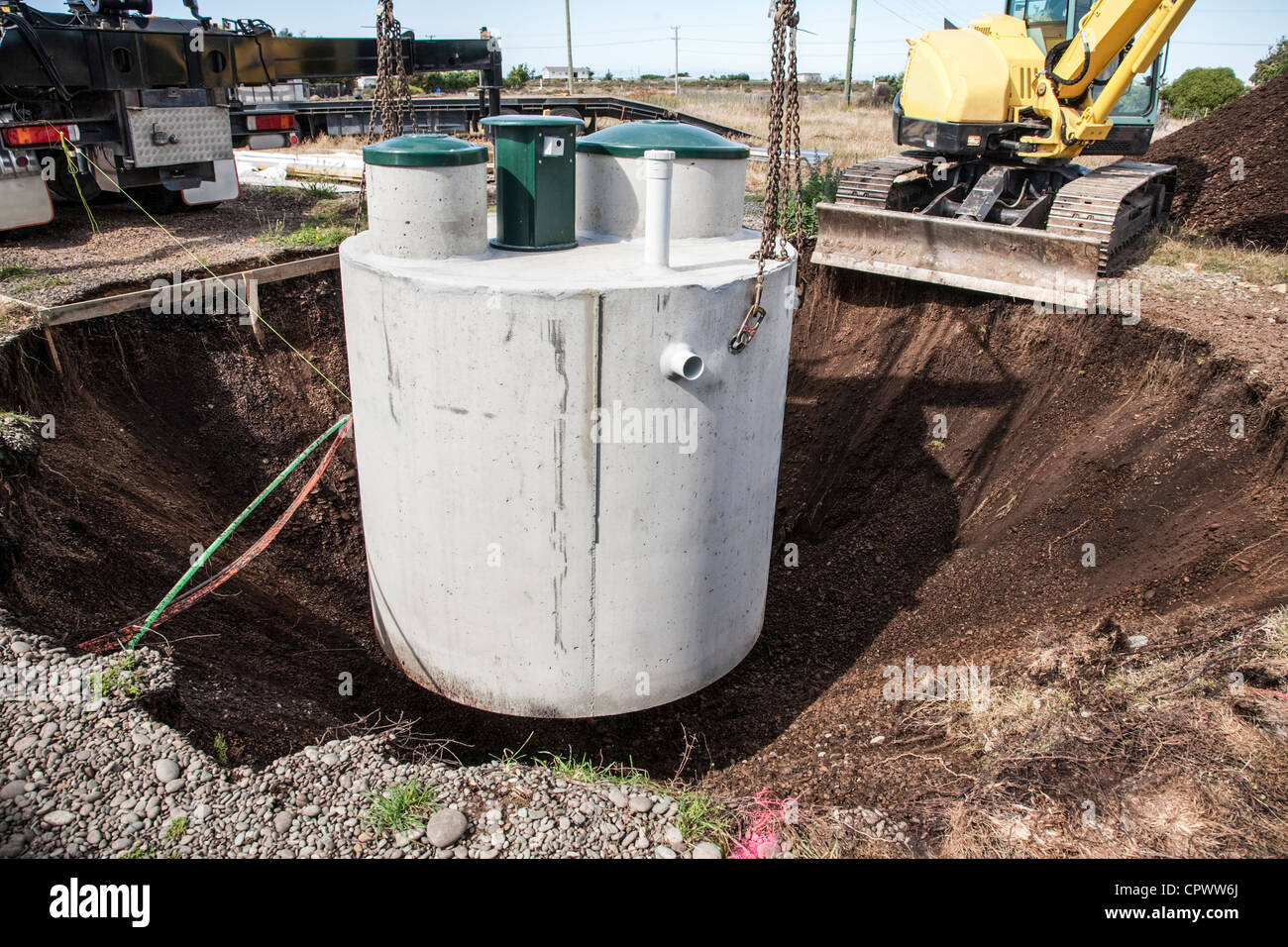 Environmentally friendly septic tank being lowered into ground. Stock Photo