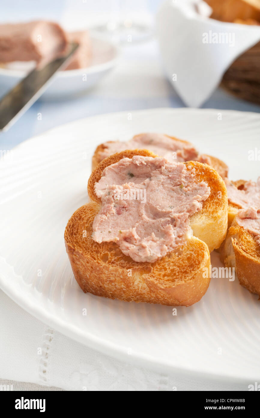 Ardennes pate spread on toasted baguette. Stock Photo