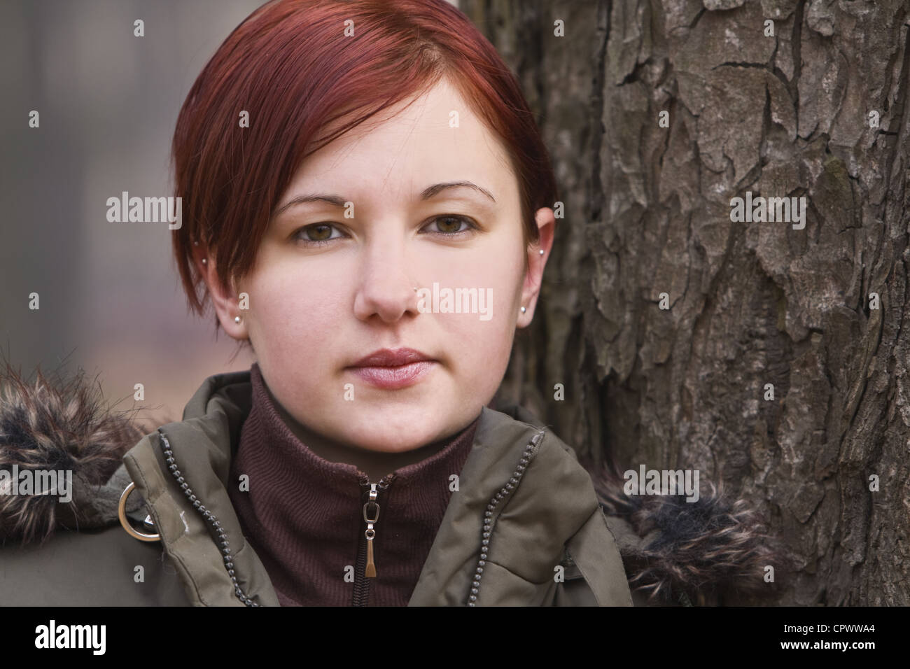 Portrait of a redheaded girl near a tree (autumn colors Stock Photo - Alamy