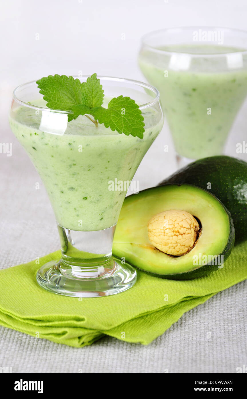 Avocado smoothie with mint leaves in glass. Healthy drink. Stock Photo