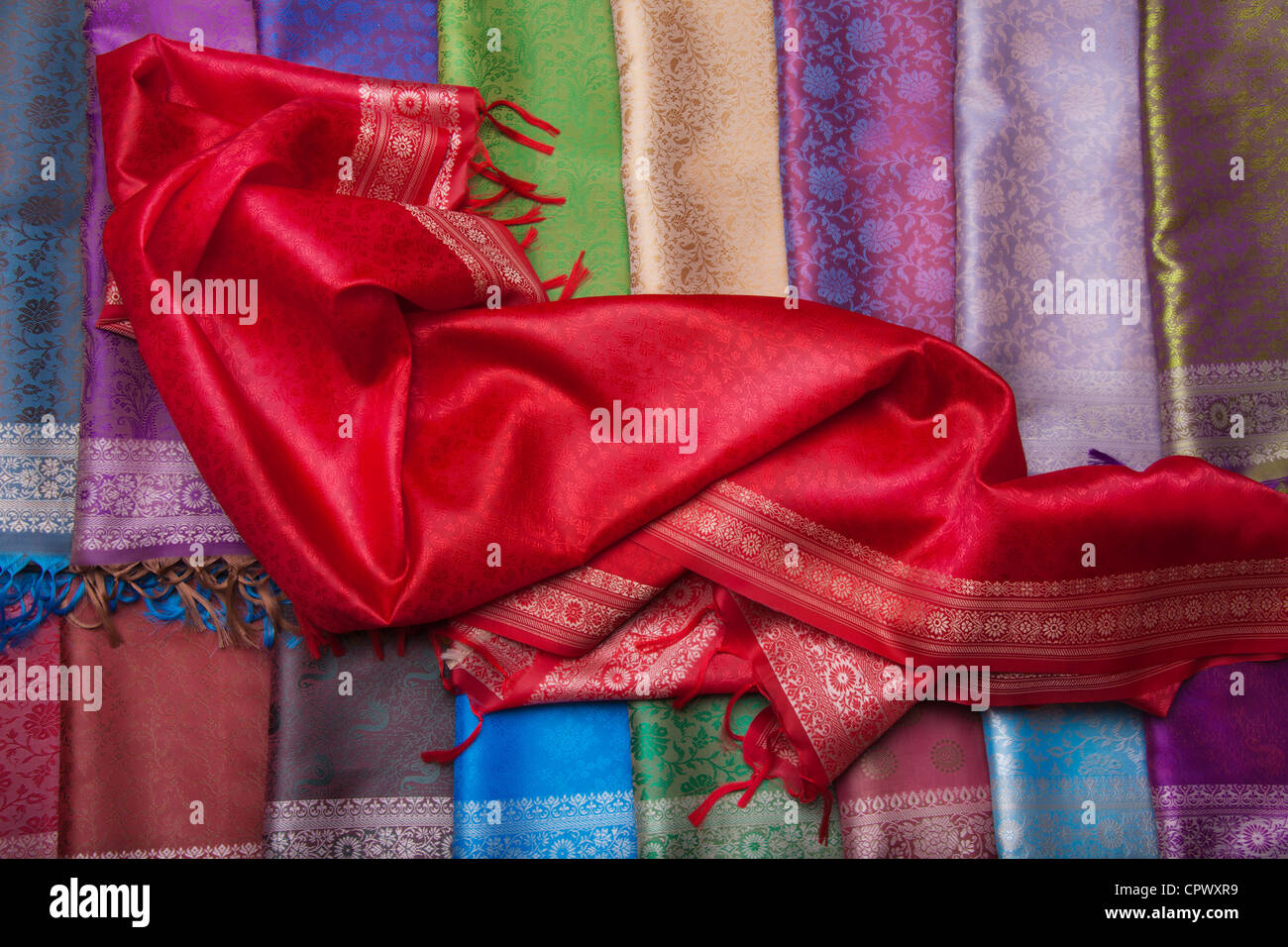 Red fabric on the counter with many different headscarfs Stock Photo