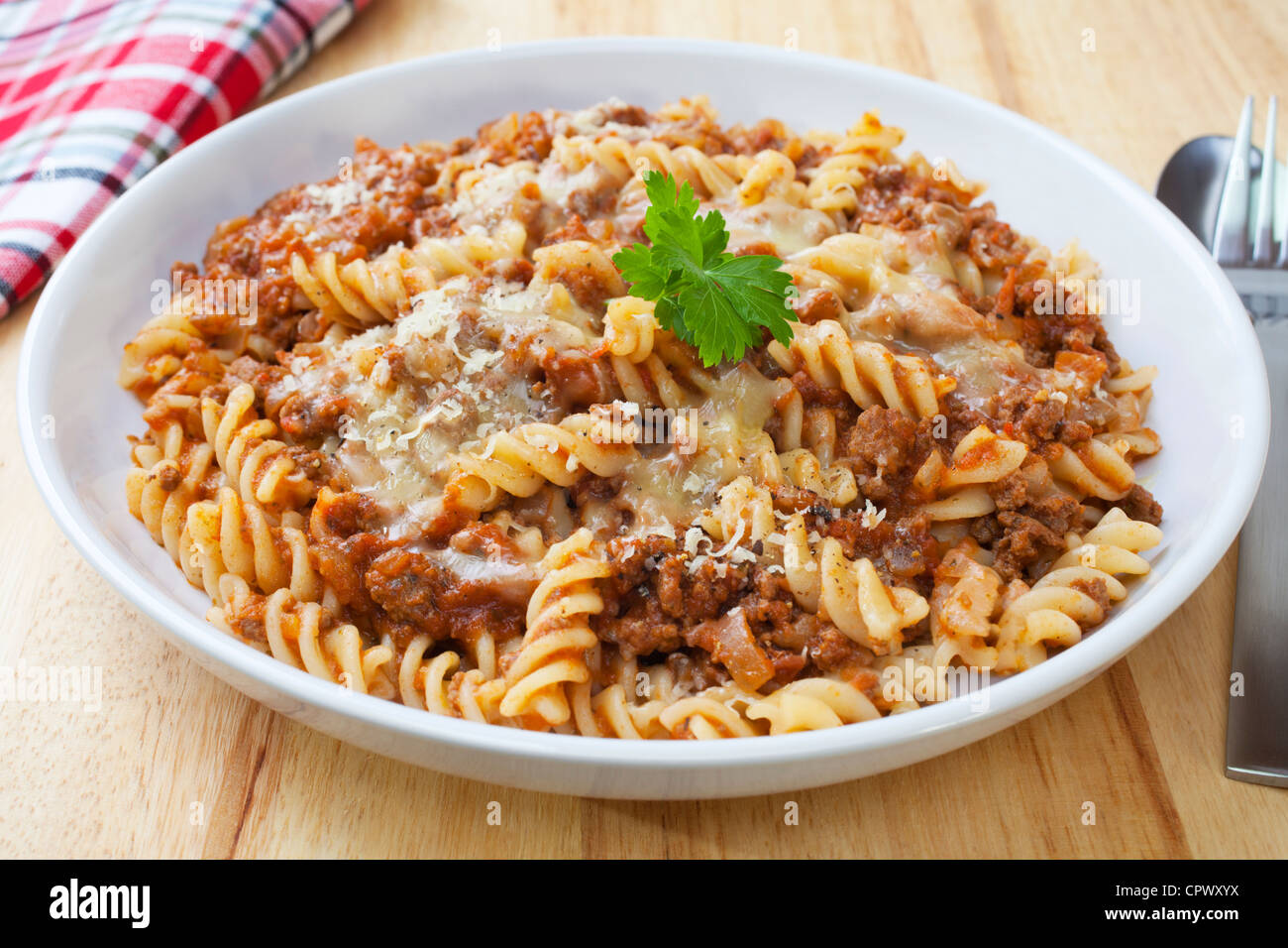 Fusili pasta baked with bolognese sauce, mozzarella and parmesan. Stock Photo