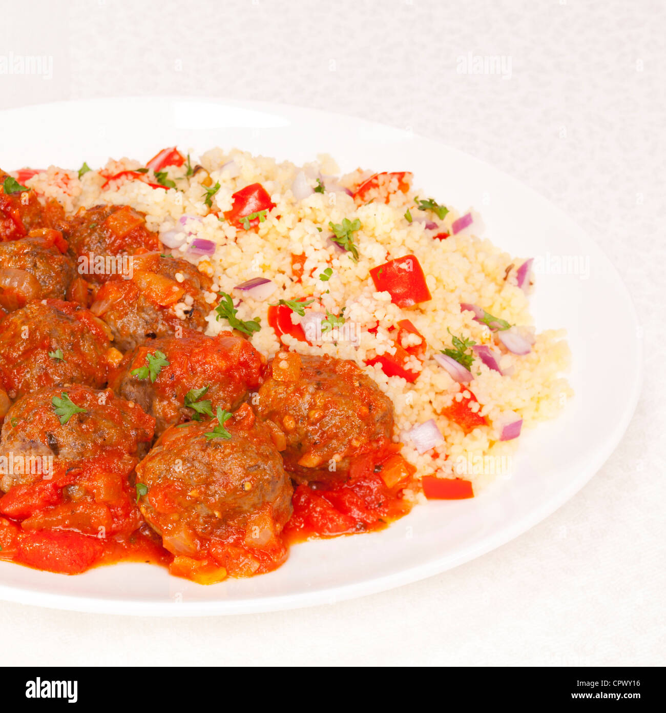 Meatballs in tomato sauce, served with couscous Stock Photo Alamy