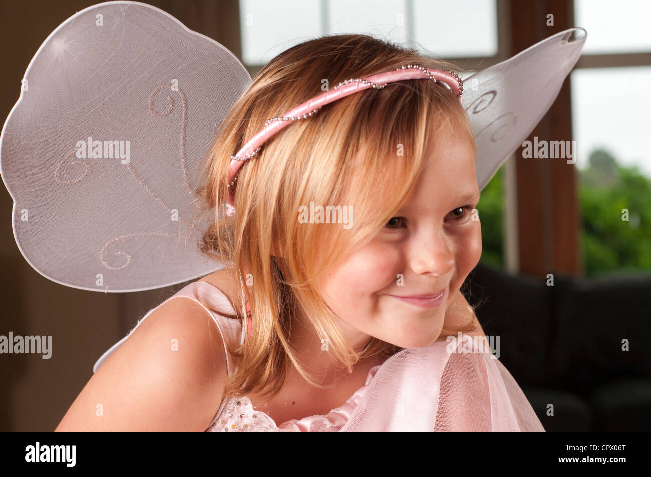 Young 7 year old in fairy outfit with wings. Stock Photo