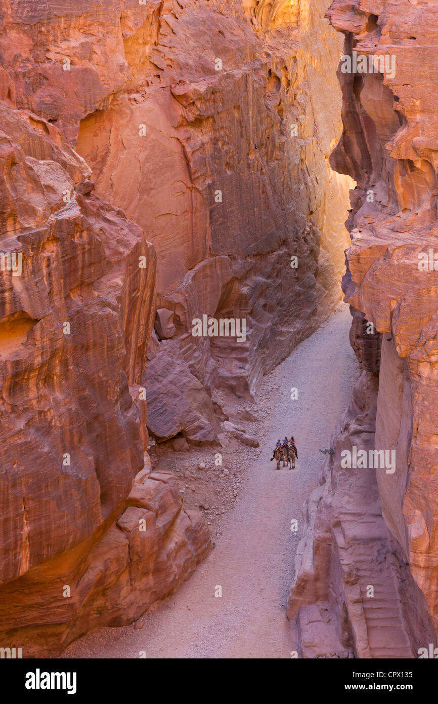 Tourists riding on camel in Al-Siq, Petra, Jordan (UNESCO World Heritage site) Stock Photo
