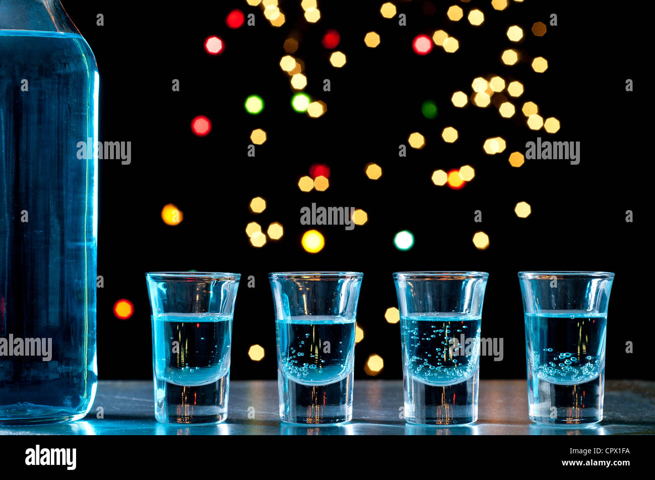 Bottle and shots of blue alcohol Stock Photo Alamy