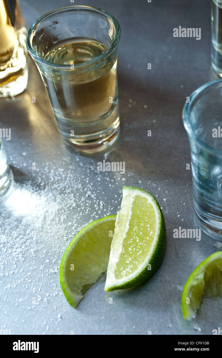 Tequila shots with lime wedges Stock Photo Alamy