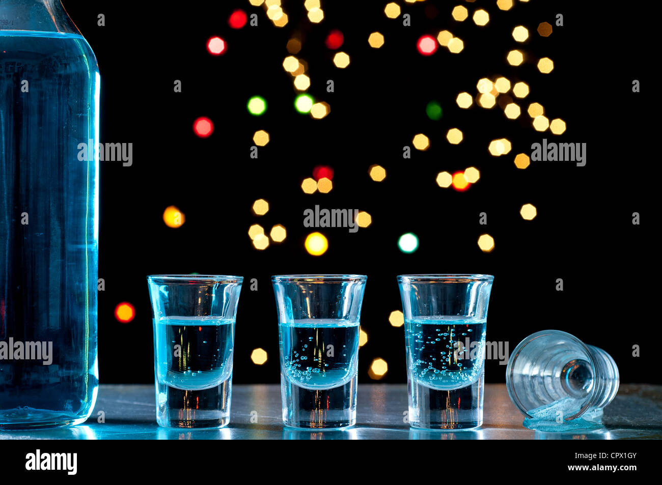 Bottle and shots of blue alcohol Stock Photo Alamy