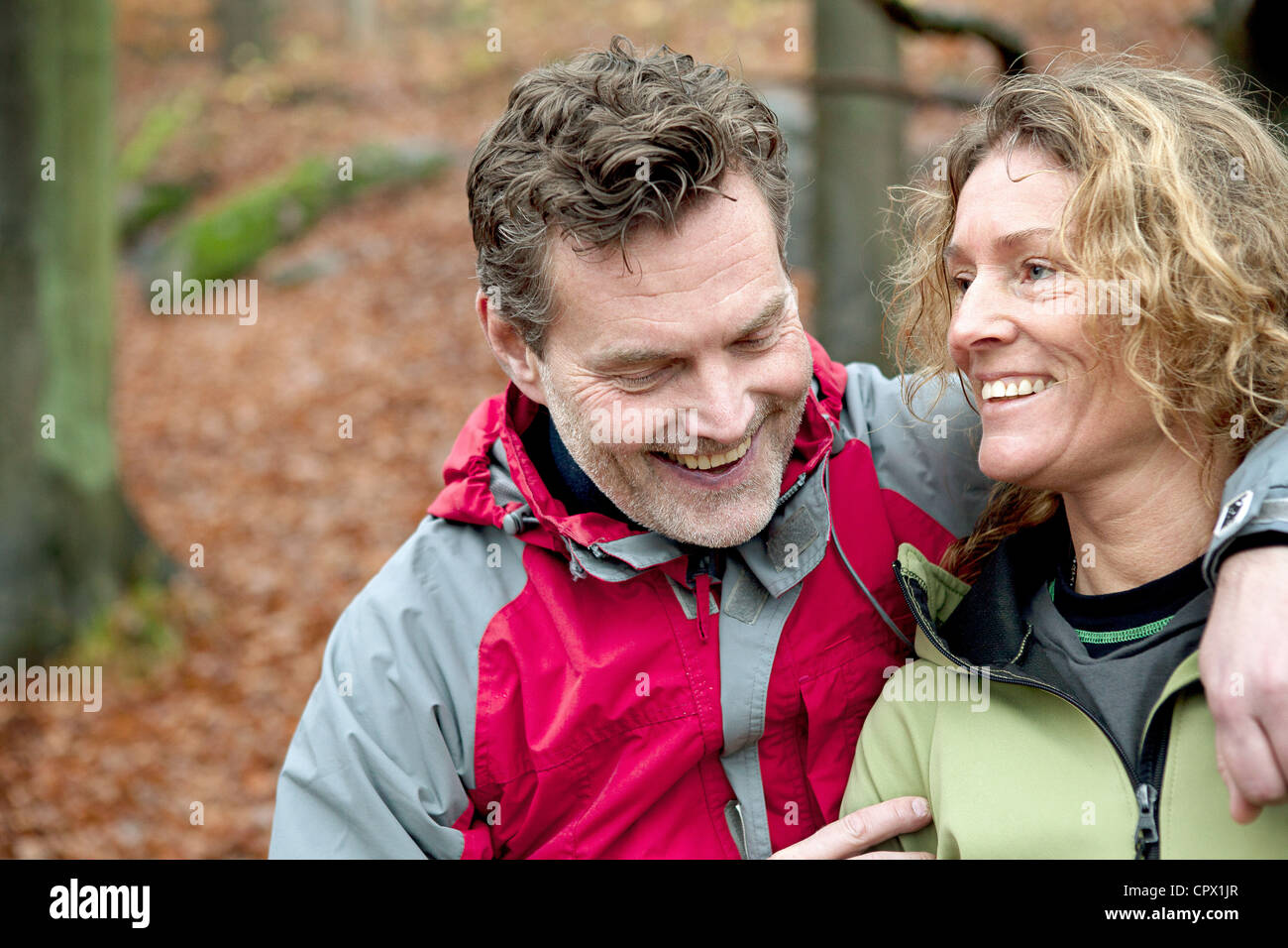 Mature couple smiling in forest Stock Photo