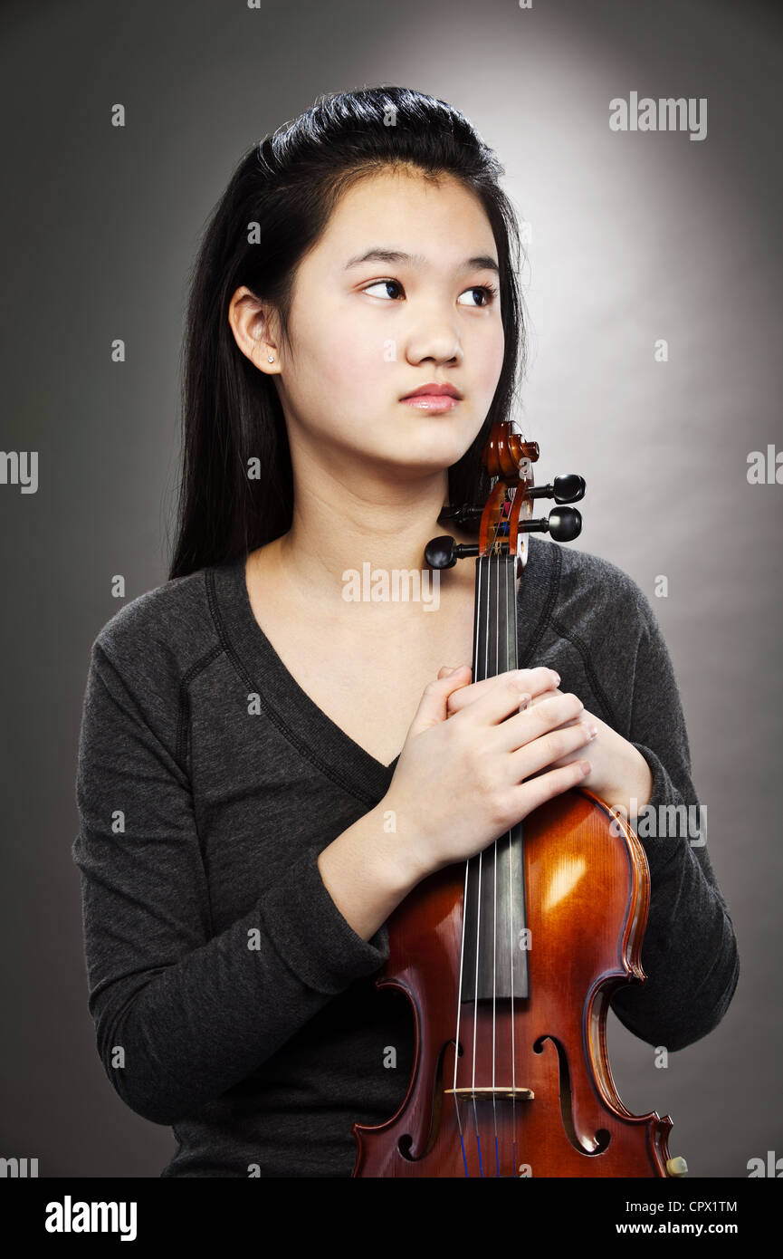 Portrait of young Asian teenage girl holding violin Stock Photo - Alamy